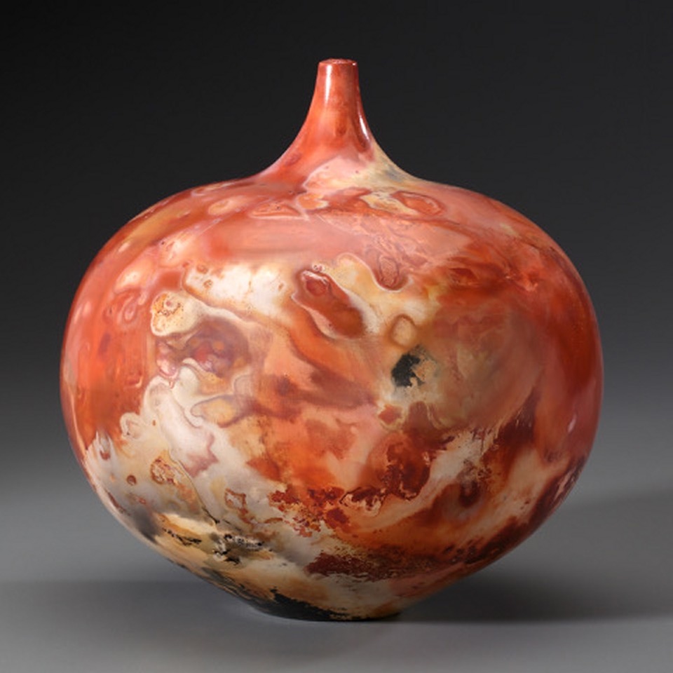 Raku fired pottery bottle with burnished red glazes