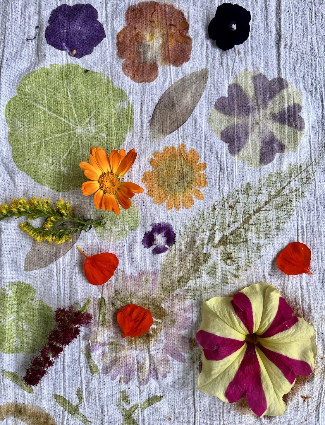 White fabric with flower and leaf prints and flowers on top
