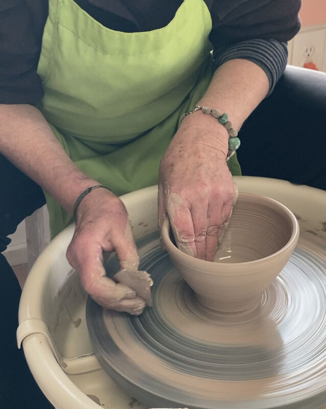 hands making bowl on a potter's wheel