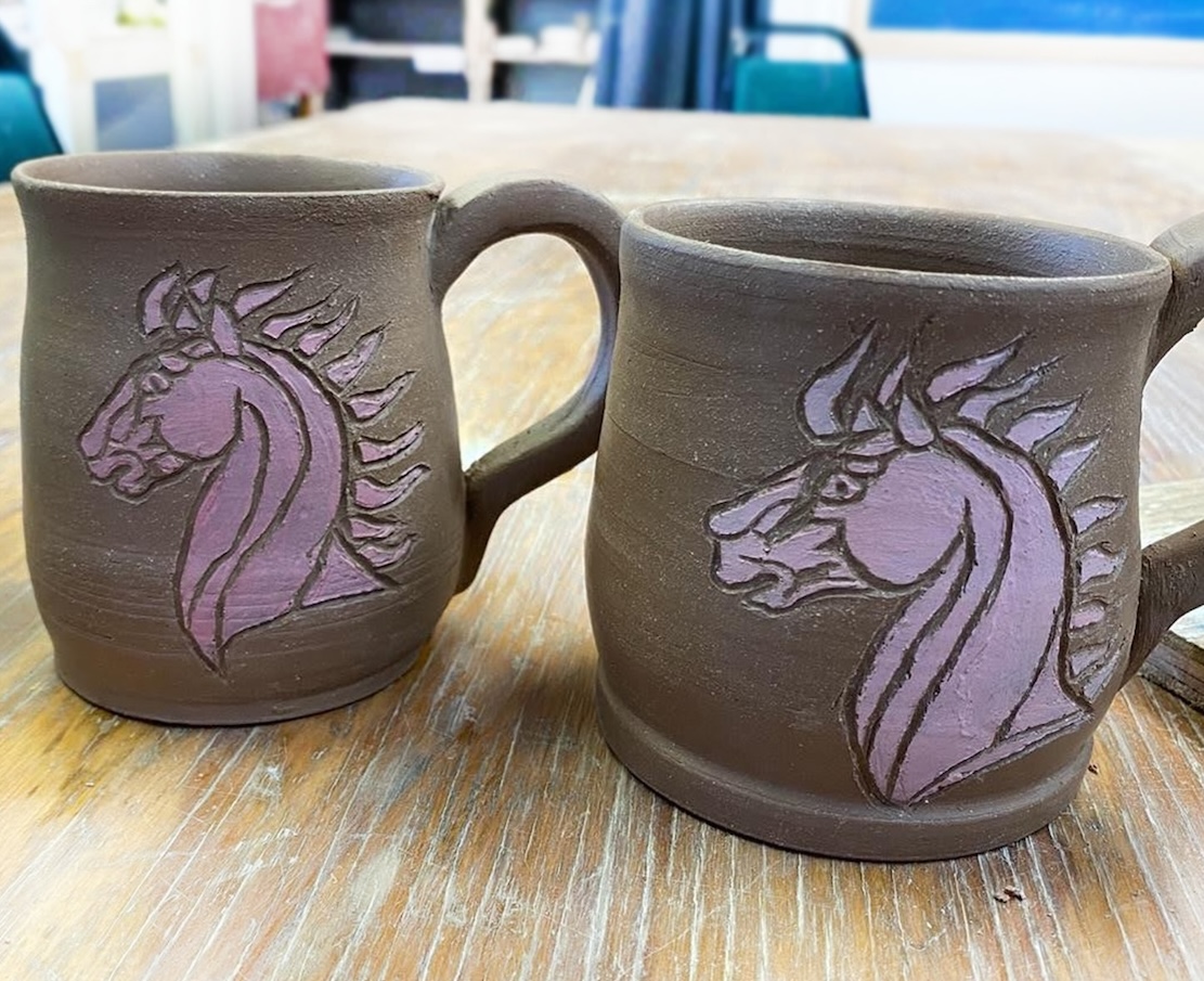 2 clay mugs with sgraffito horse design