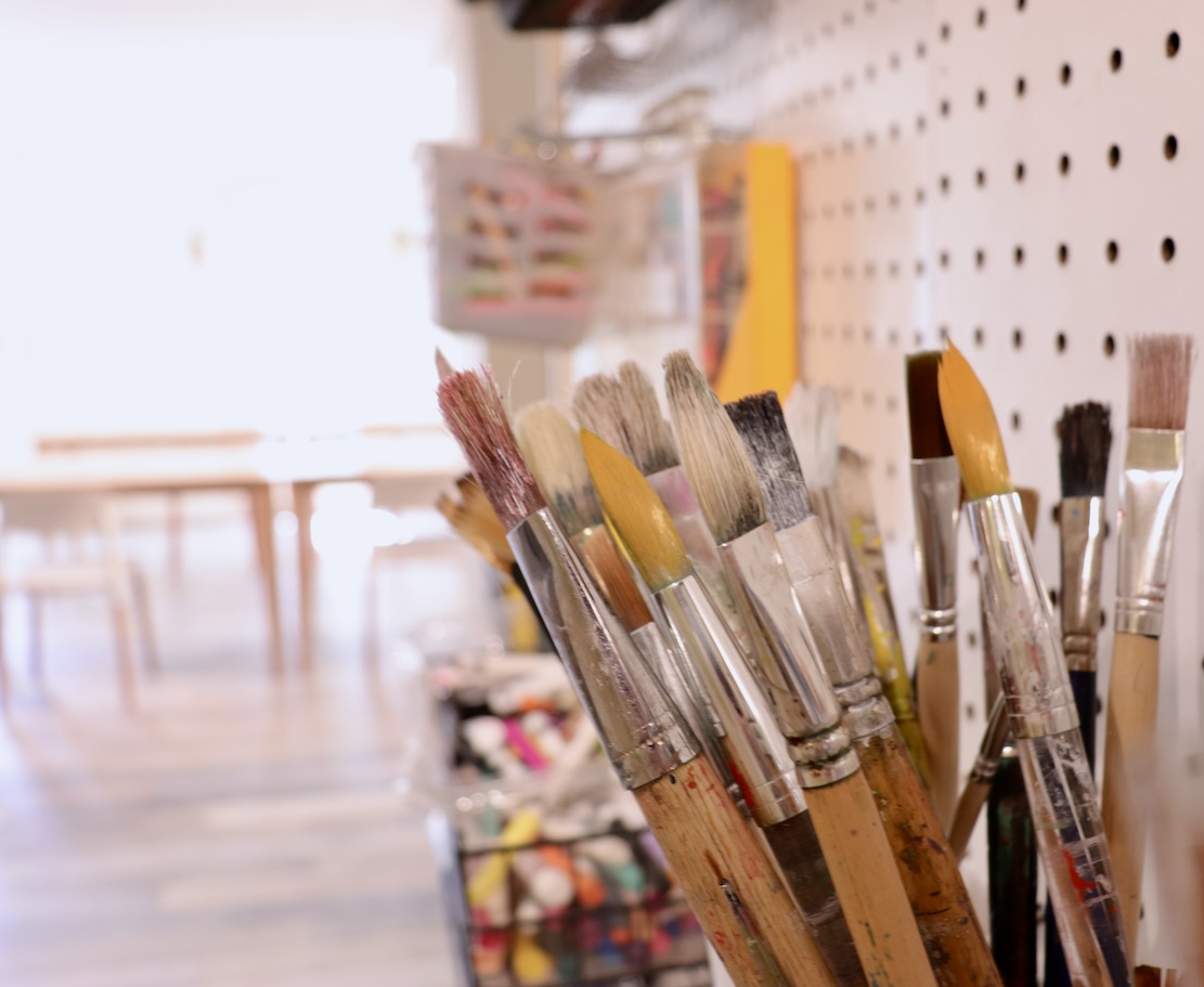 Brushes on pegboard in art studio