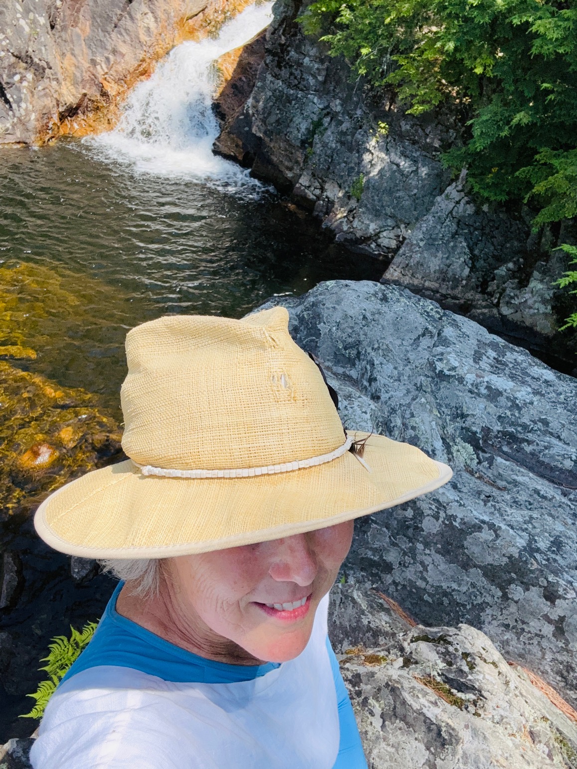 Woman with hat by river