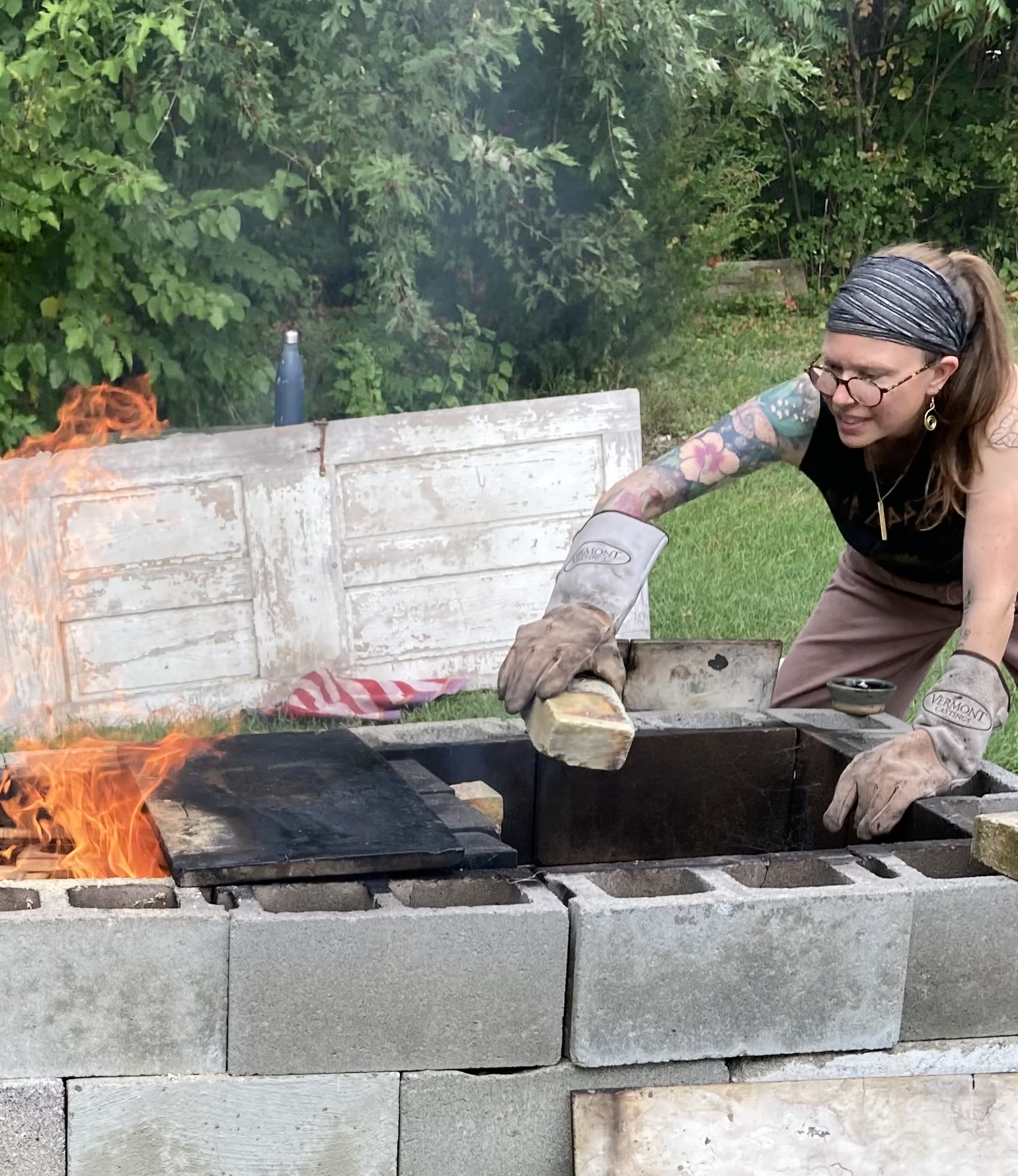 Potter pit firing pieces outside