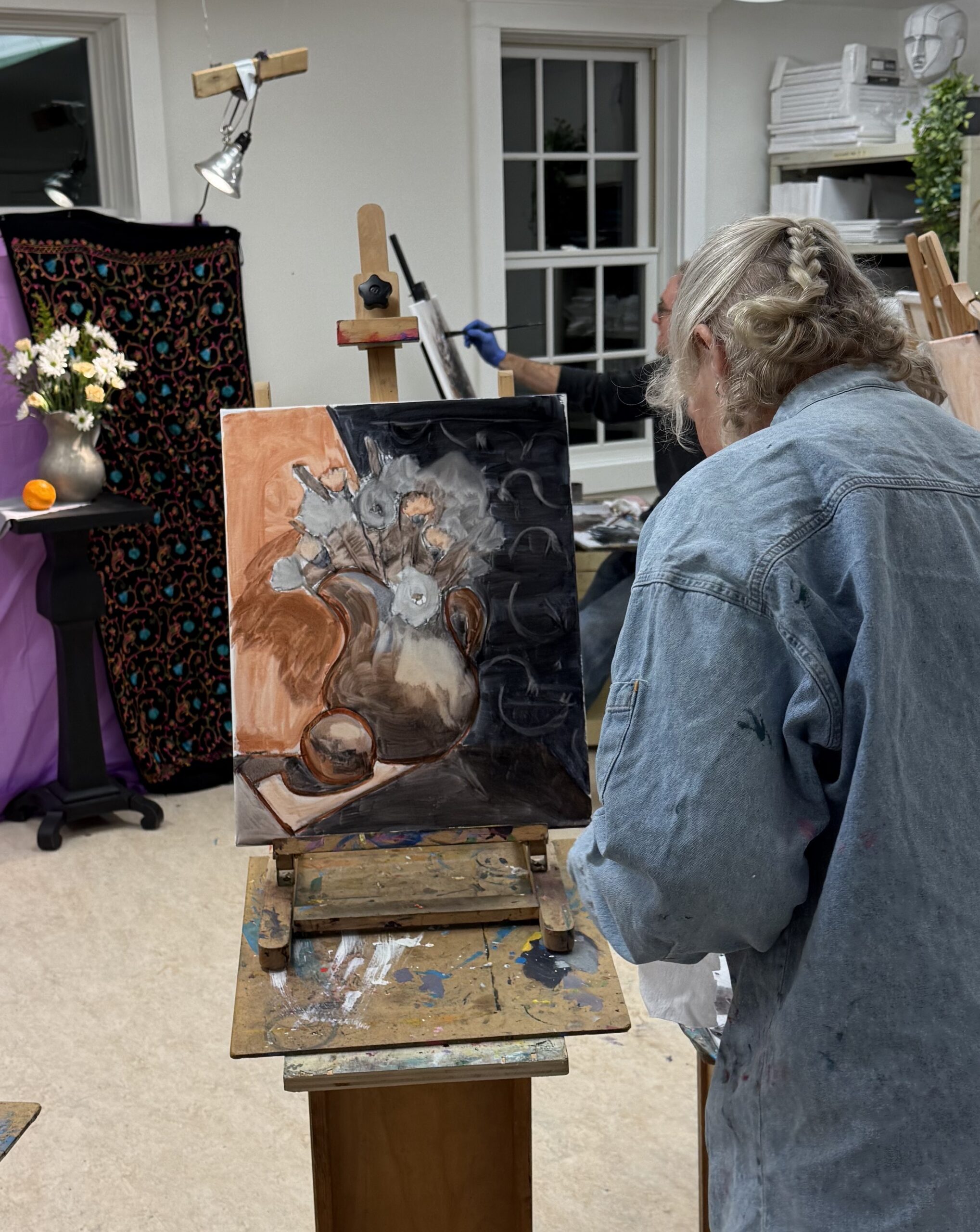 Woman holding up indigo dyed Shibori fabric