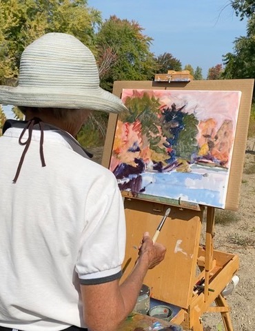 Woman holding up indigo dyed Shibori fabric