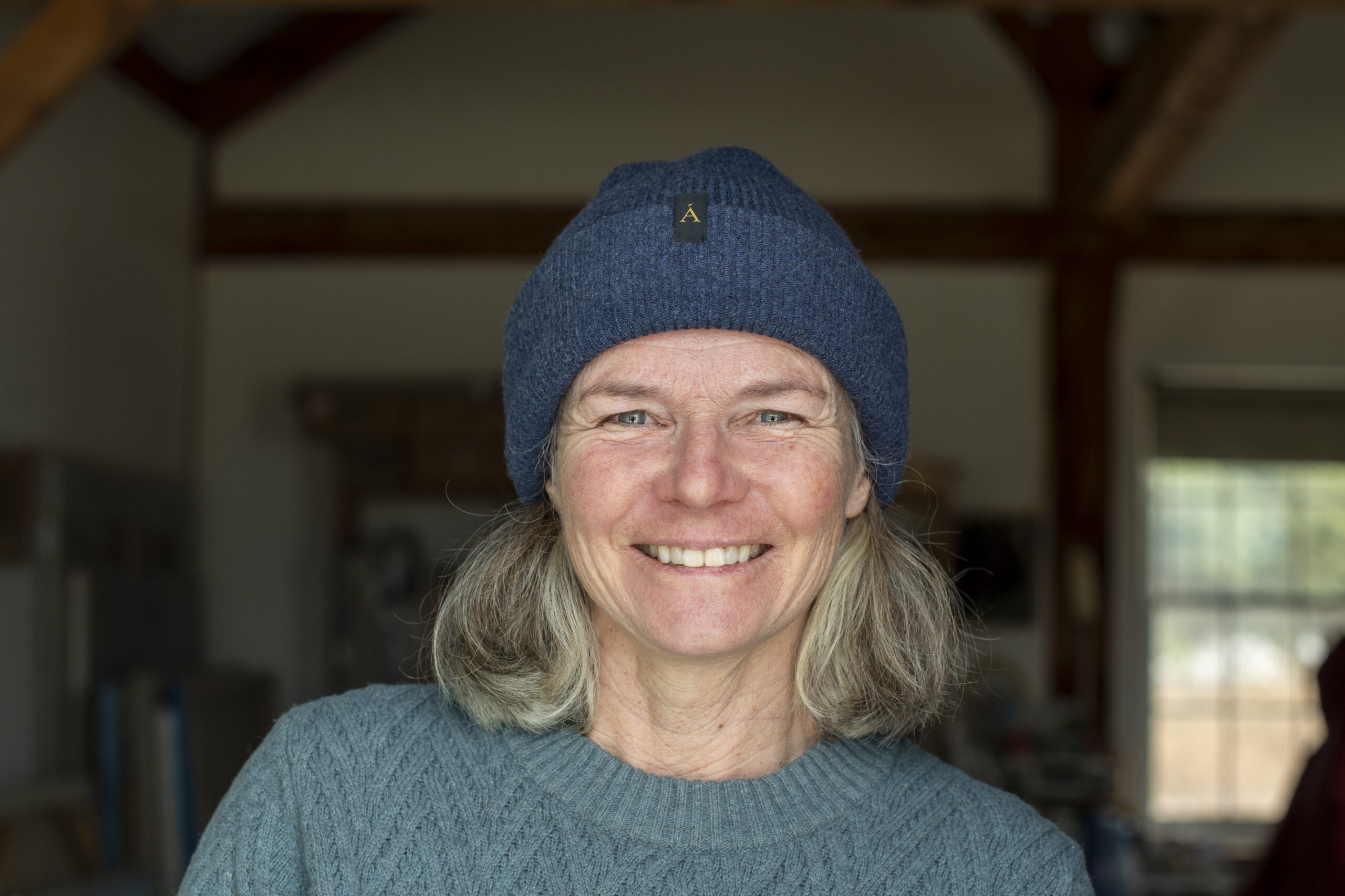 Headshot of woman wearing a blue hat