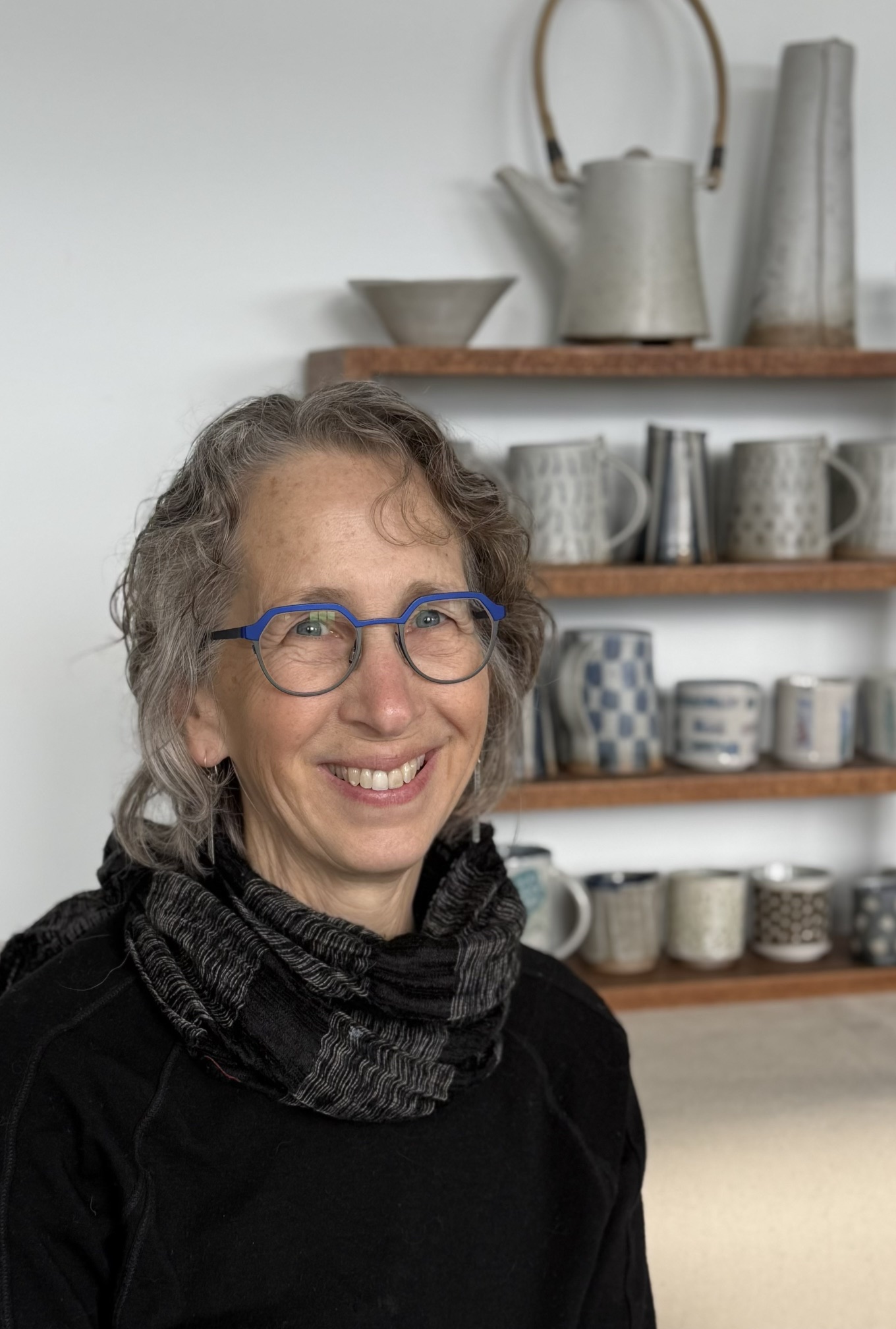 Woman in front of handmade pieces